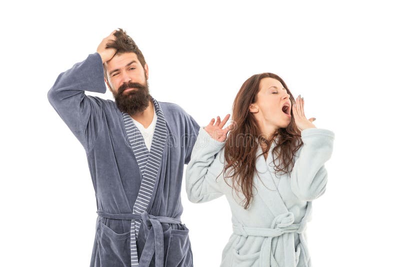 Couple of yawning men and women in robes isolated on white, sleepy. Couple of yawning men and women in robes isolated on white, sleepy.