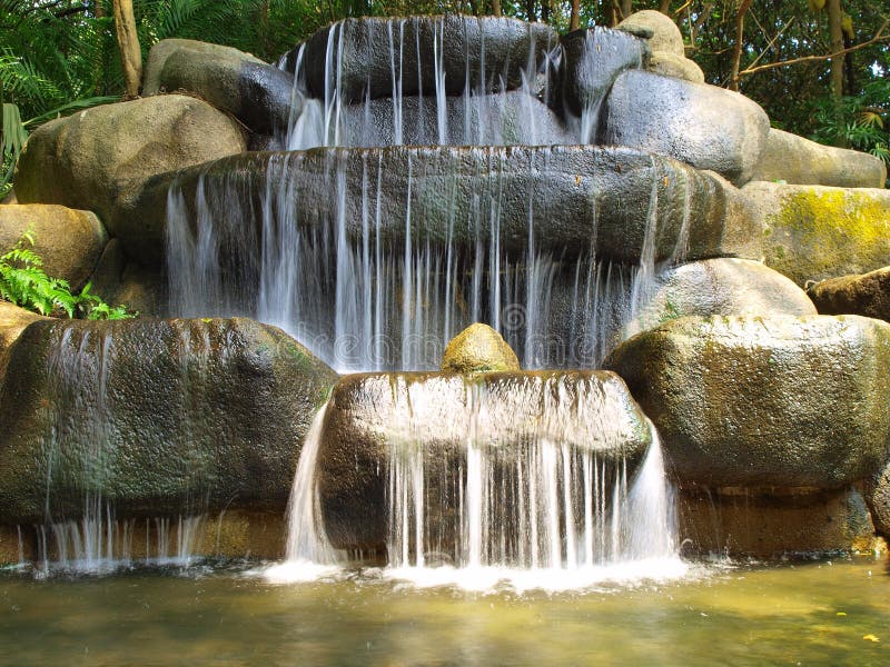 Deep in the rainforest, a waterfall offers respite from the humidity. Deep in the rainforest, a waterfall offers respite from the humidity.