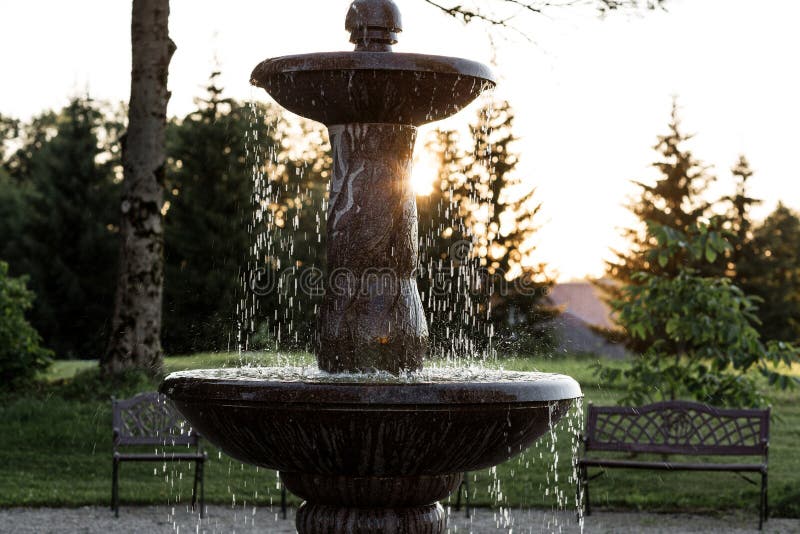 Cascade granite water fountain in the park stock photos Cascade granite water fountain in the park stock photos