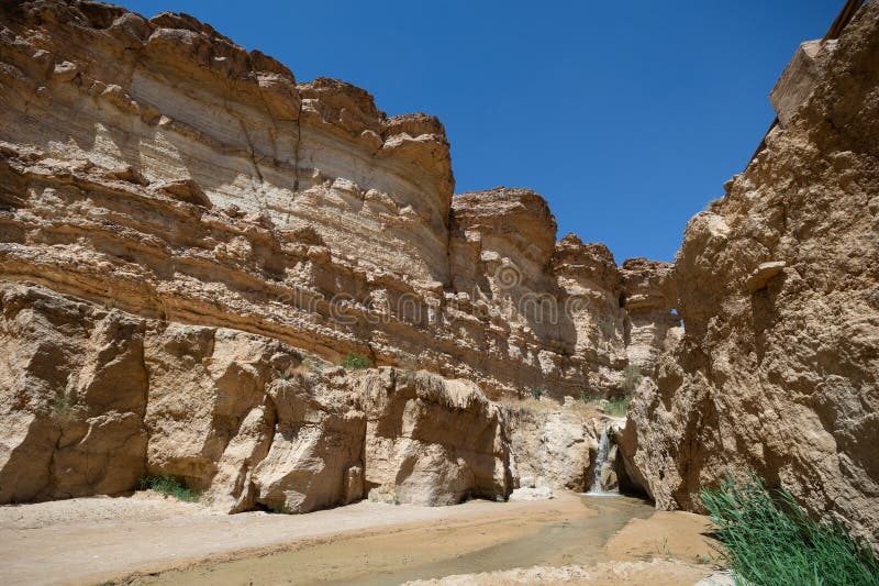 Waterfall cascading through desert canyon in Tamaqzah, Tunisia, Africa. Waterfall cascading through desert canyon in Tamaqzah, Tunisia, Africa