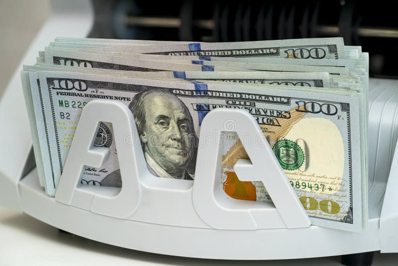 Cash counting machine processes stacks of hundred dollar bills stock image