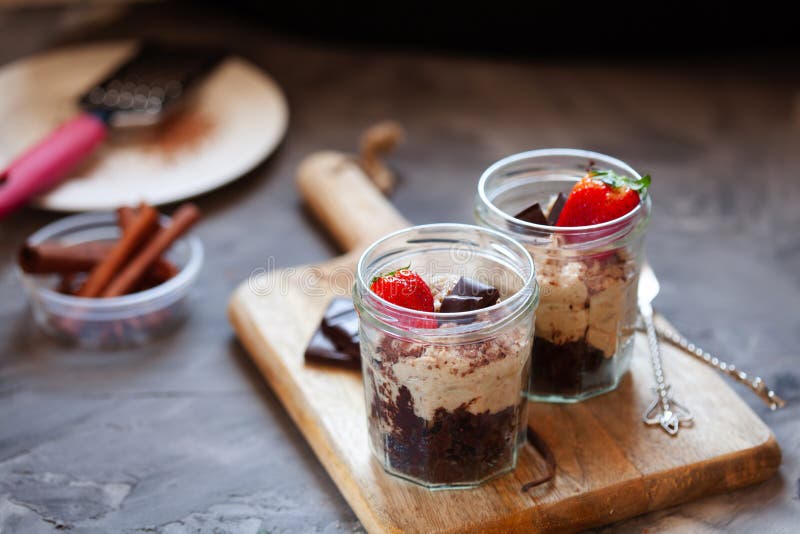 Cashew and dates vegan tiramisu with chocolate in portion jars. Healthy dessert
