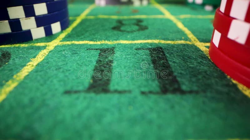 Casino gambling chips on roulette green felt table