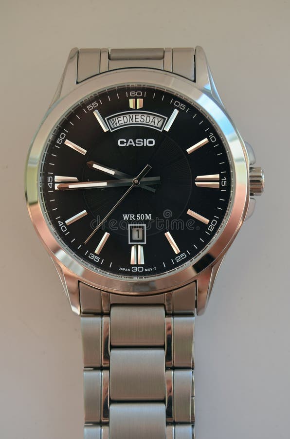 Closeup with casio watch, metal band, black dial, flat glass, day and date. Closeup with casio watch, metal band, black dial, flat glass, day and date