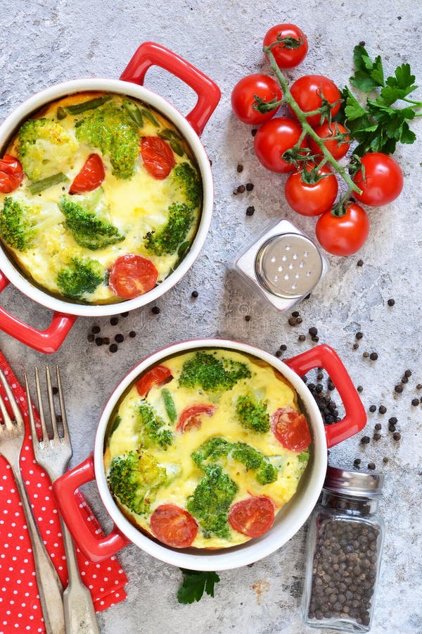 Casserole with Broccoli and Tomatoes on a Concrete Background. View ...