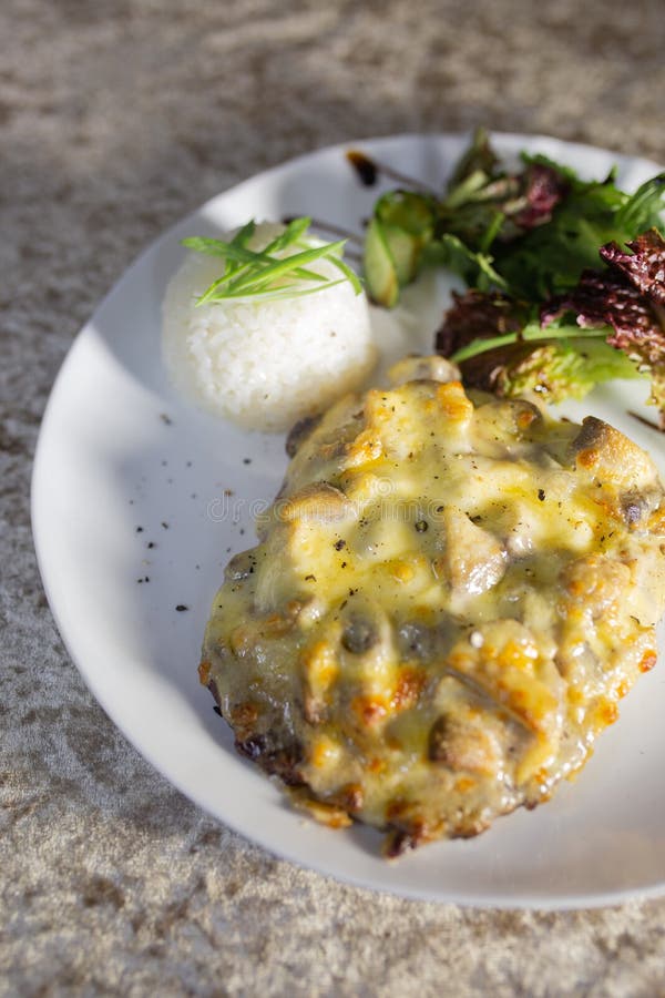 mushroom casserole with rice and herbs on a white plate. mushroom casserole with rice and herbs on a white plate.