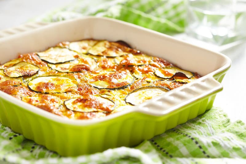 Casseruola con formaggio e lo zucchini nel piatto di cottura fotografia stock libera da diritti Casseruola con formaggio e lo zucchini nel piatto di cottura fotografia stock libera da diritti