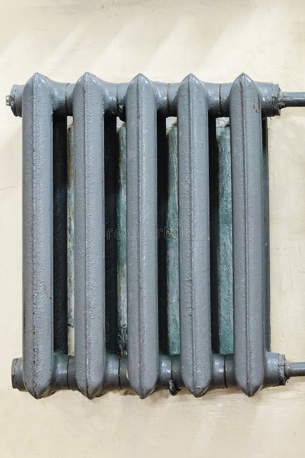 Castiron Gray Radiator for Heating Hanging on the Wall Stock Image