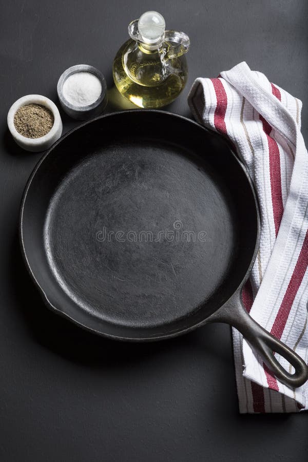 Cast Iron Skillet with Copy Area on Black Background with Ingredients