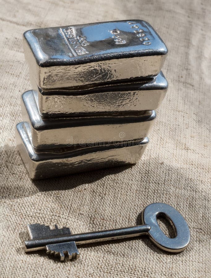 Cast Silver Bars and the Key To the Safe Against a Rough Texture of the