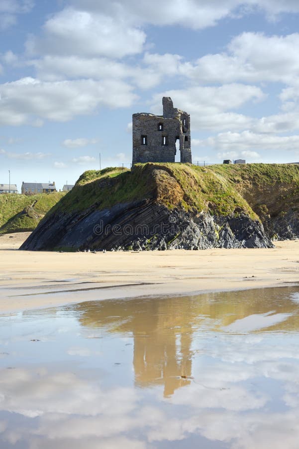 Castle and beach with beautiful reflection of the clouds