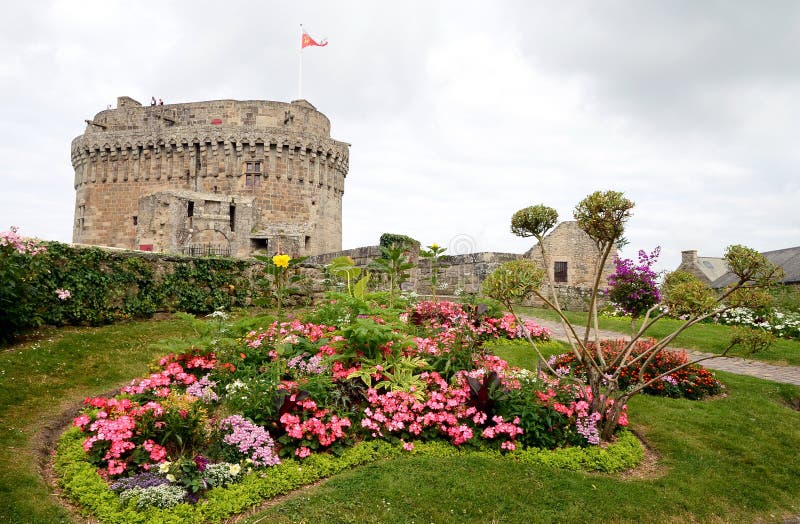 Castle of Dinan with beautiful flowers in forefront, Brittany, France. Castle of Dinan with beautiful flowers in forefront. The medieval Breton town on the stock photography Castle of Dinan with beautiful flowers in forefront, Brittany, France. Castle of Dinan with beautiful flowers in forefront. The medieval Breton town on the stock photography