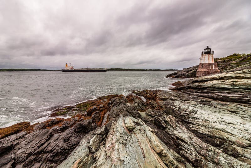 Castle Hill Lighthouse in Newport, Rhode Island, situated on a dramatic rocky coastline