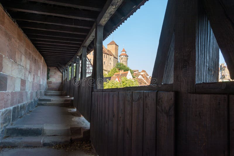 The castle of Nuremberg in the afternoon sun from the guards walkway with a wooden roof
