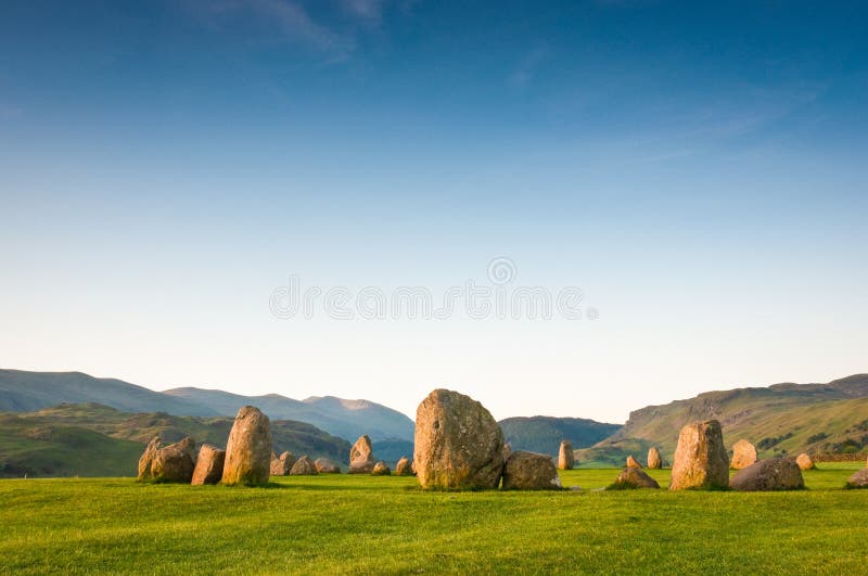 Ancient Castlerigg stone circle (3200 BC) illuminated by warm early morning sunlight in the Lake District UK. Ancient Castlerigg stone circle (3200 BC) illuminated by warm early morning sunlight in the Lake District UK.