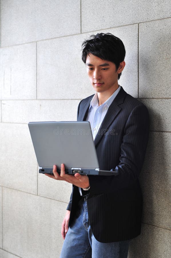 Casual Asian Man with laptop stock photography Casual Asian Man with laptop stock photography