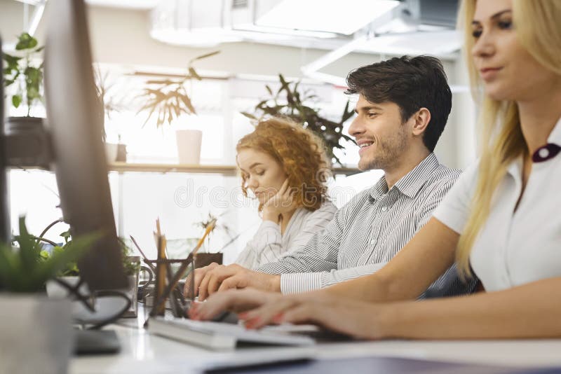 Casual business people working on computers in office royalty free stock image Casual business people working on computers in office royalty free stock image