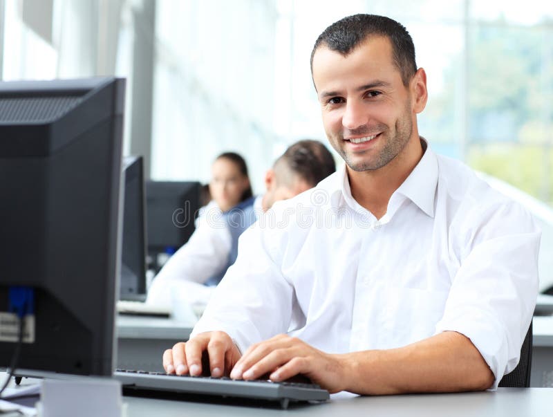 Casual businessman using laptop in office