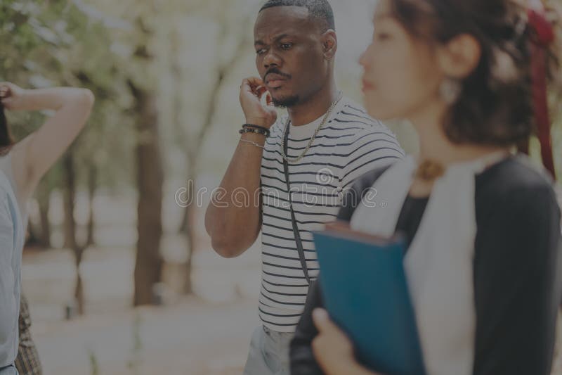 Casual businesspeople discussing outside in a park setting stock photography