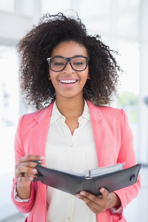 Casual Businesswoman Holding Her Diary Smiling at Camera Stock Image ...