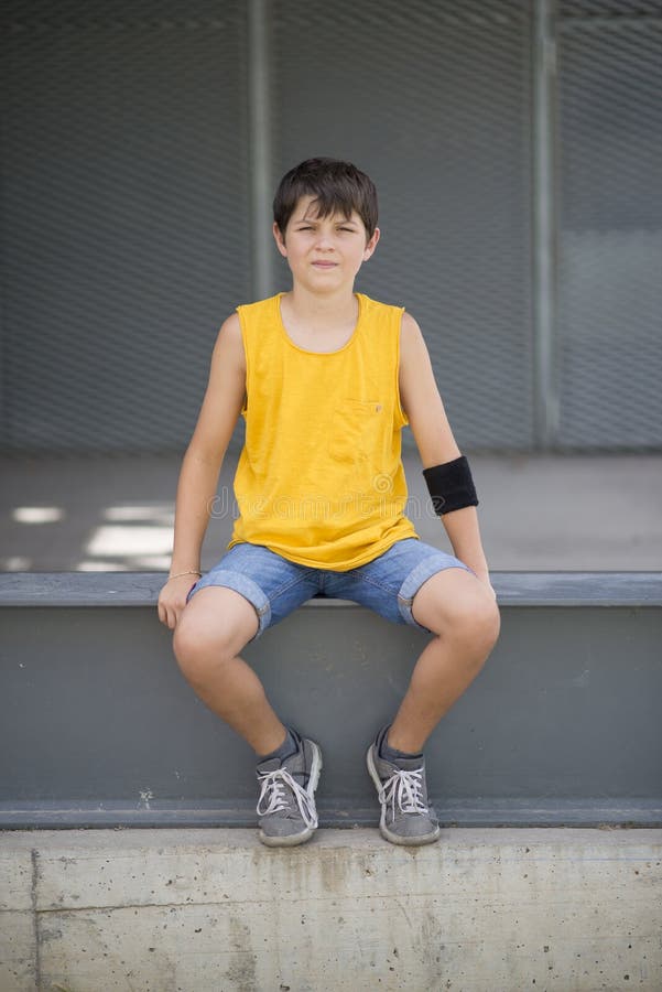 Casual dressed young smiling teen skater outdoors portrait