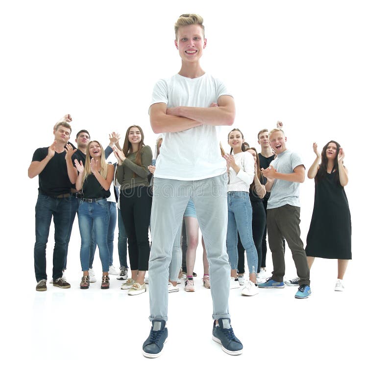 Casual guy and a group of diverse young people standing in a spacious hall. royalty free stock image