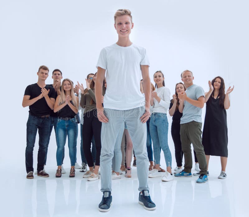 Casual guy standing in front of a group of diverse young people royalty free stock photos