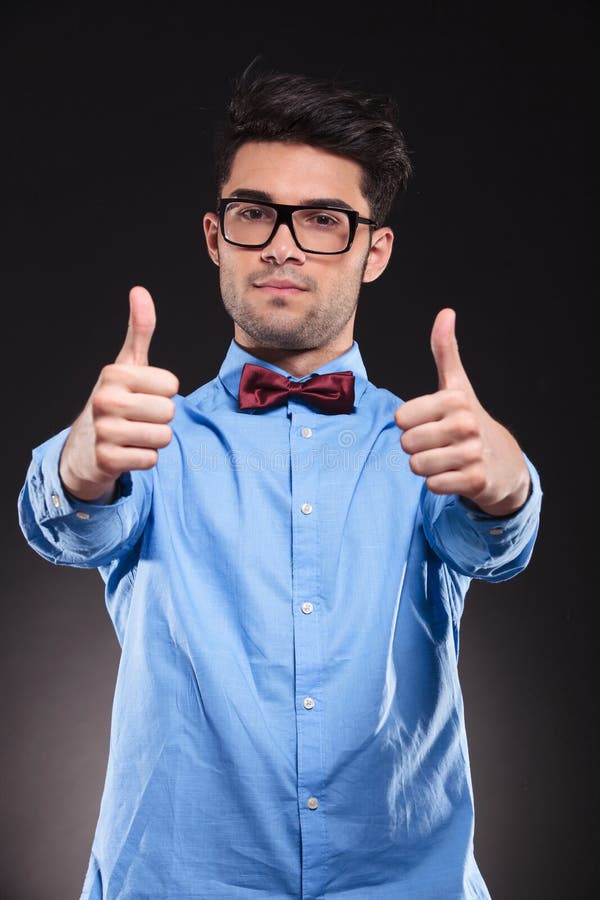 Casual guy standing and giving a double thumbs-up