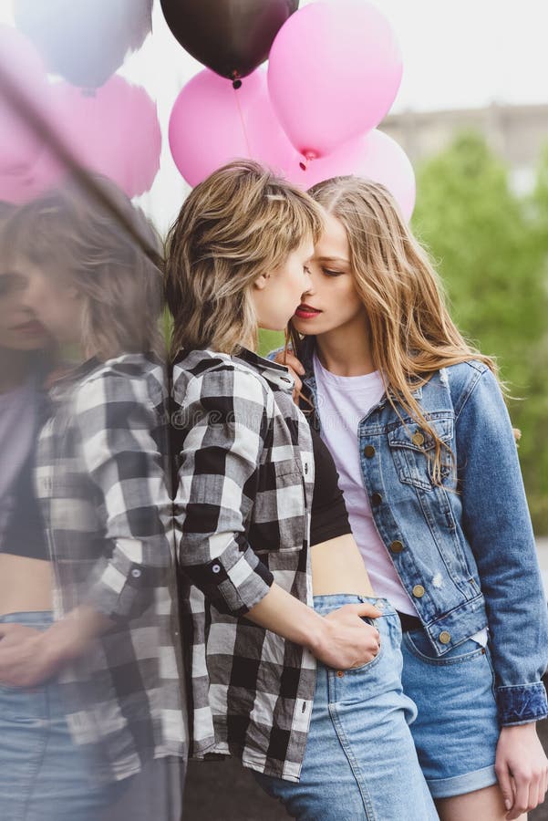 Casual Lesbian Couple Kissing And Holding Air Balloons Outdoors Stock Image Image Of Intimate