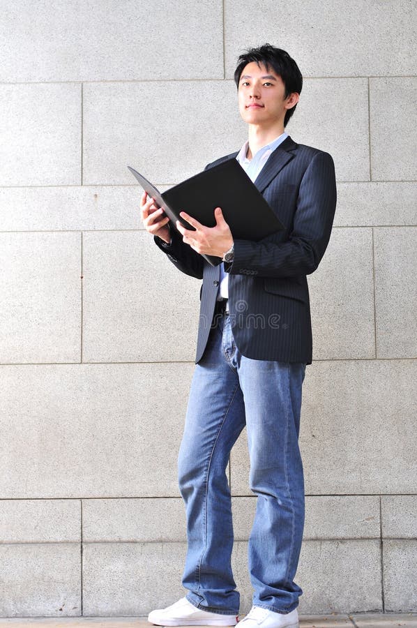 Casual Looking Asian Man reading