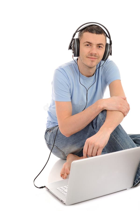 Casual man listening to music in headphones