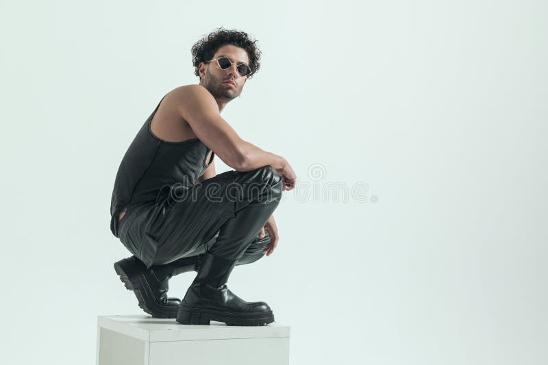 casual man squatting chair posing attractive casual man squatting chair posing wearing leather costume 270479504
