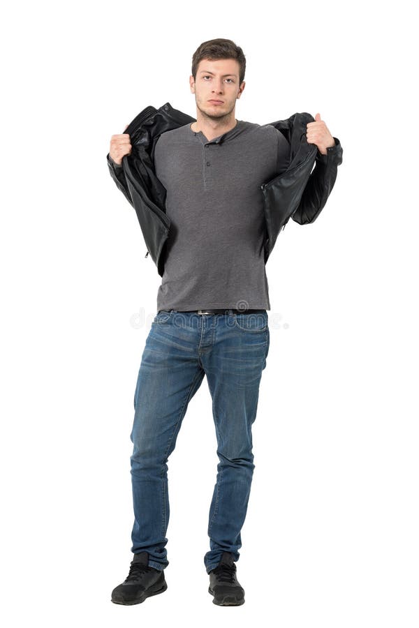 Casual man taking off jacket looking at camera