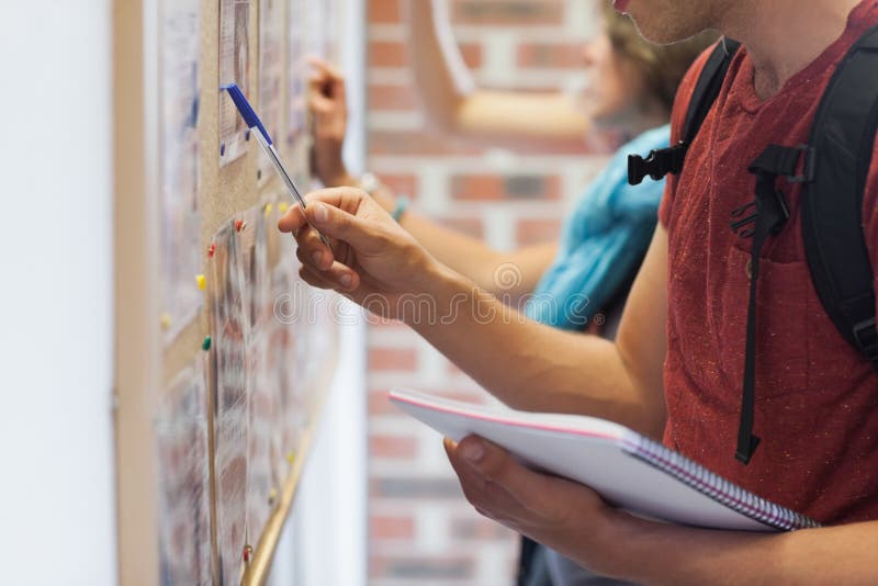 Casual Students Searching Something on Notice Board Stock Image Image