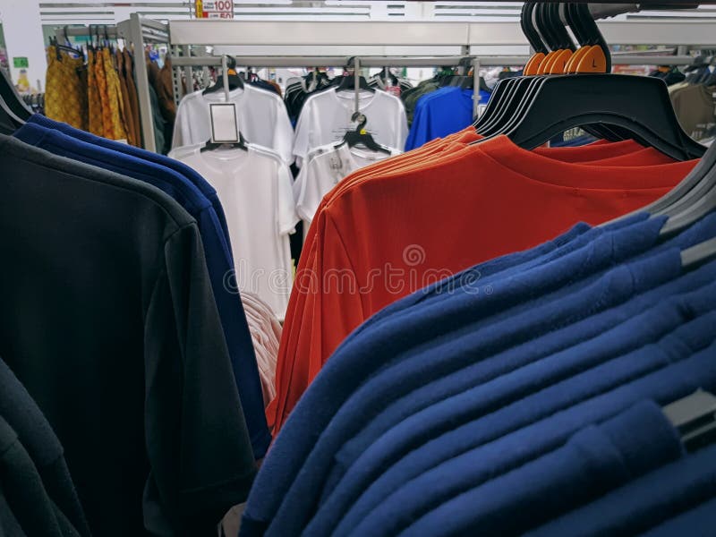 Colorful T-Shirts Hanging on Rack at Retailed Store Stock Photo - Image ...