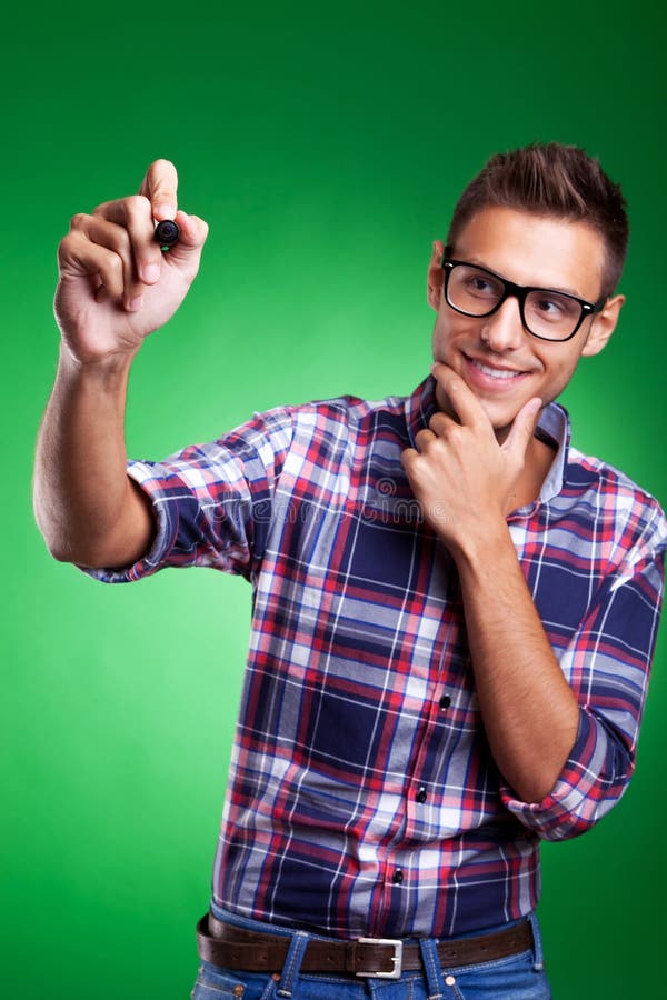 Casual young man writing with marker