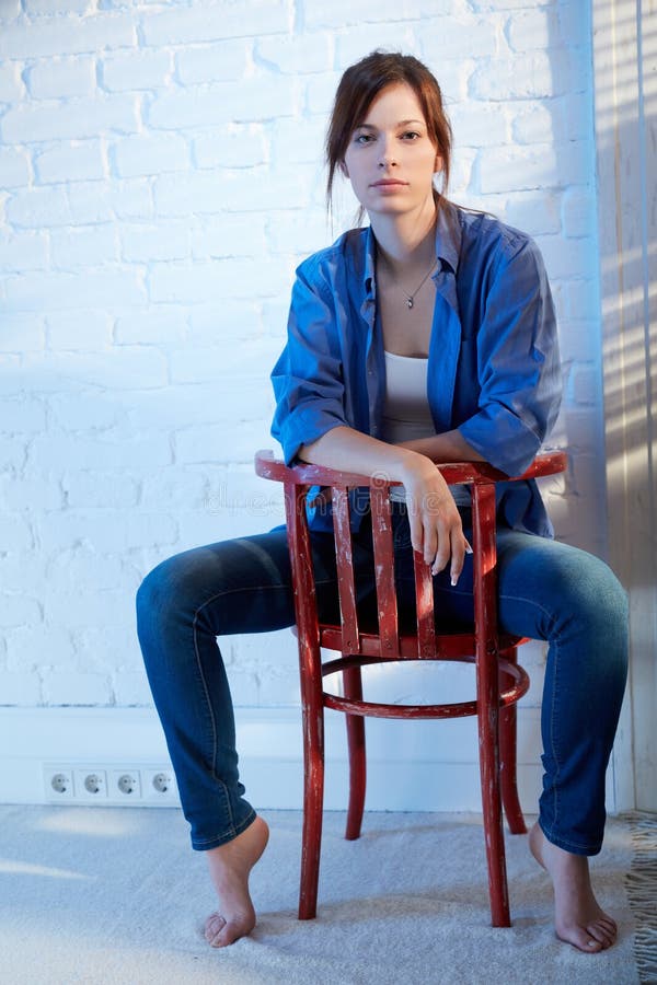 Casual young woman sitting on chair. 
