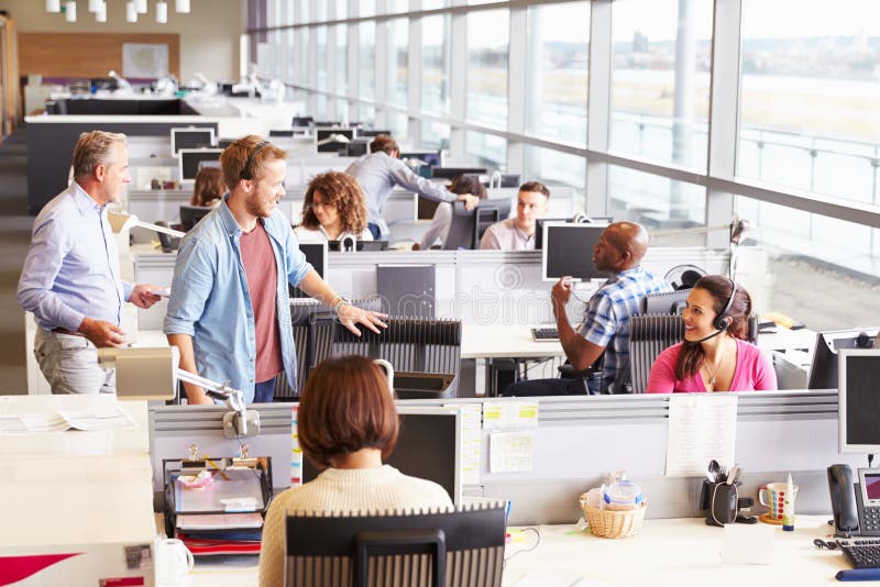 Casually dressed colleagues talking in an open plan office stock images Casually dressed colleagues talking in an open plan office stock images