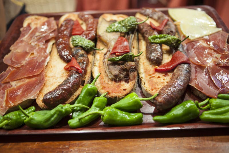 Catalan sandwiches with jamon and tomato and sausage