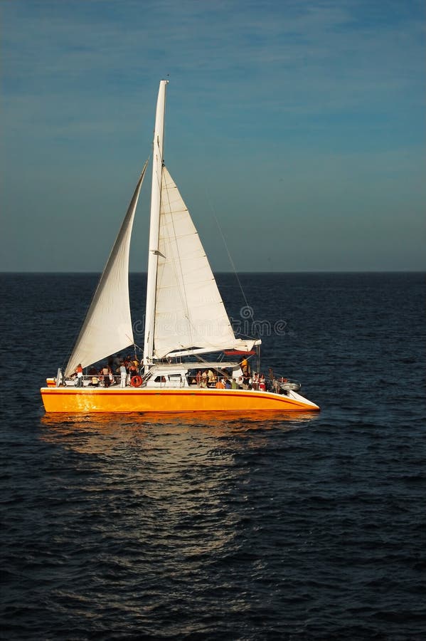 Catamaran at sea in the sunset