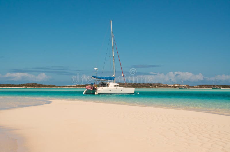 Catamaran Sailboat anchored in turquoise waters of the Bahamas. Catamaran Sailboat anchored in turquoise waters of the Bahamas.