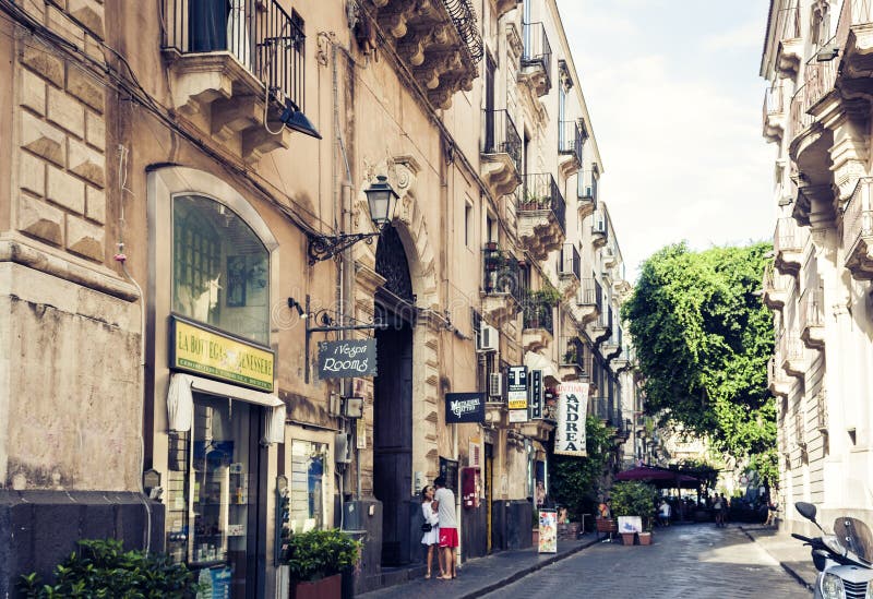 Catania, Sicily, Italy – august 8, 2018: young man and woman are kissing at the entrance to the hotel in old building on royalty free stock photo Catania, Sicily, Italy – august 8, 2018: young man and woman are kissing at the entrance to the hotel in old building on royalty free stock photo