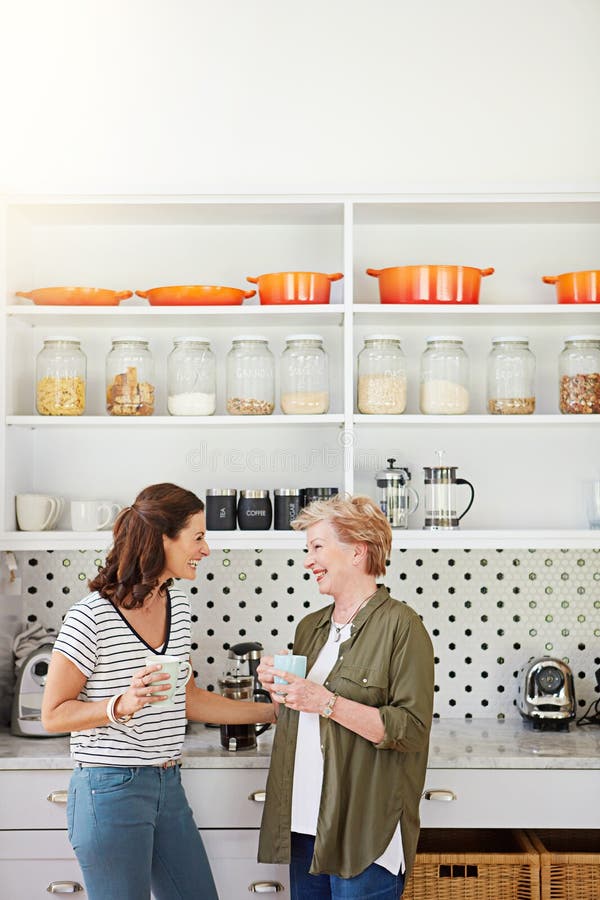 Catching Up With Mom In The Kitchen A Woman And Her Elderly Mother Catching Up Over Coffee In