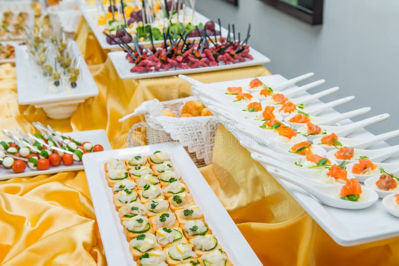 Catering table with dishes and snacks on the business event in the hotel hall. Service at business meeting, party, weddings. Selec