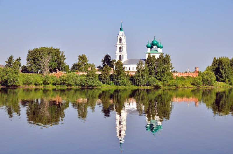 Cathedral with bell tower and his reflection in water