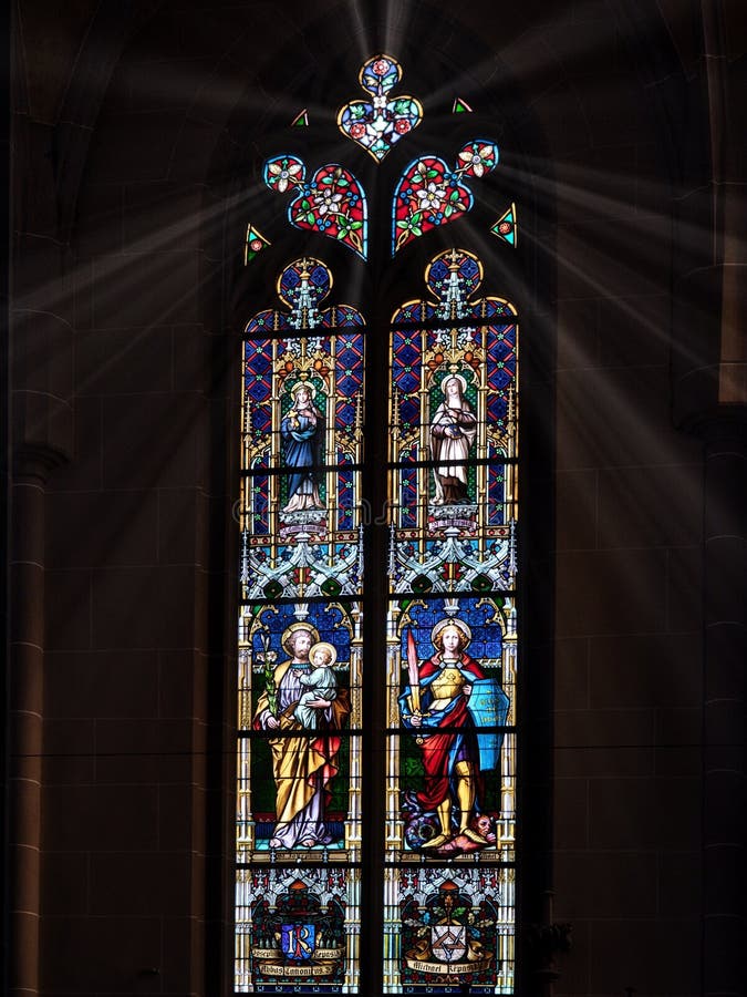 Cathedral window illuminated by sunlight