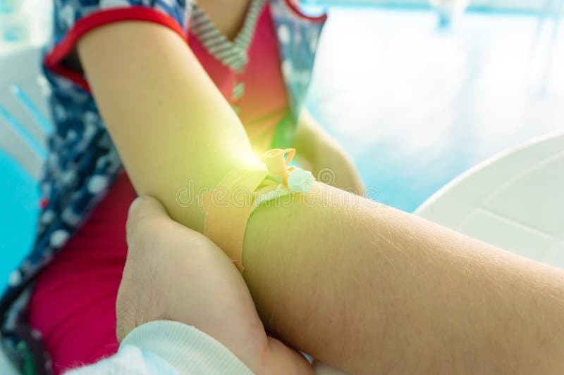 The catheter is in the girl’s hand, and the doctor examines the patient stock photos The catheter is in the girl’s hand, and the doctor examines the patient stock photos
