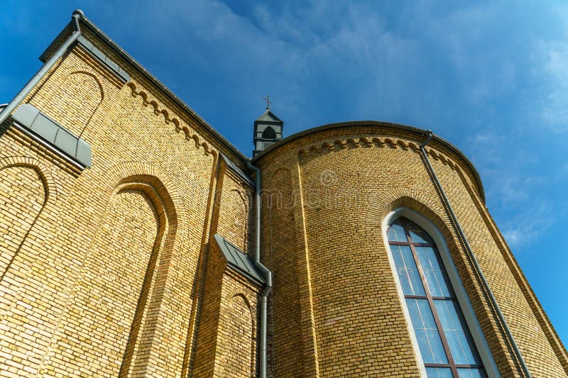 The Catholic church. The old red brick church. A historical building with a religious purpose royalty free stock photography
