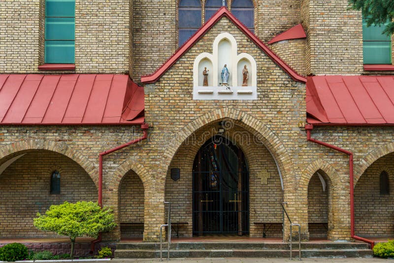 The Catholic church. The old red brick church. A historical building with a religious purpose stock photos