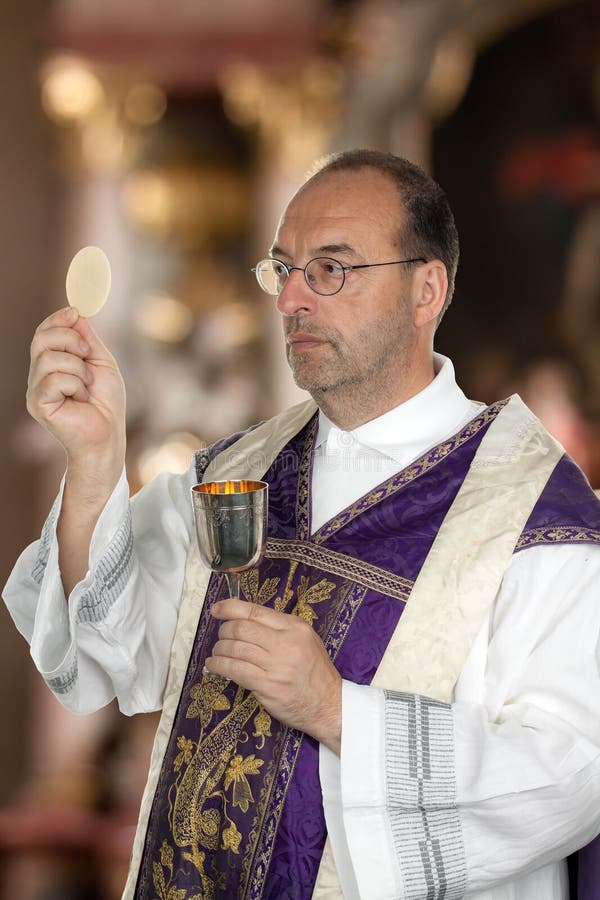 A Catholic priest in the Communion in worship in the church. A Catholic priest in the Communion in worship in the church